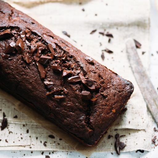 A delicious Bakendales chocolate loaf, with a rich chocolate color and a slight crack on top, indicating a moist interior.