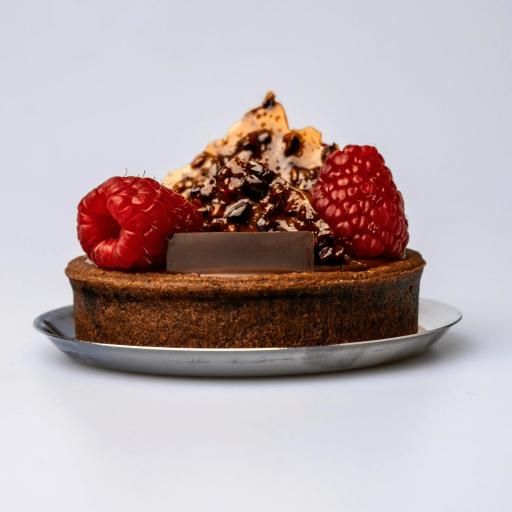 A rich Bakendales chocolate tart, with a glossy, dark chocolate filling and a perfectly crimped crust.